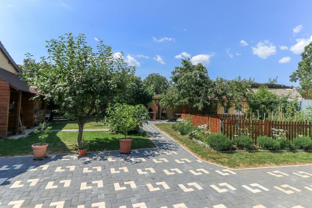 a courtyard with trees and a fence at NIKAS APARTMENT in Sibiu