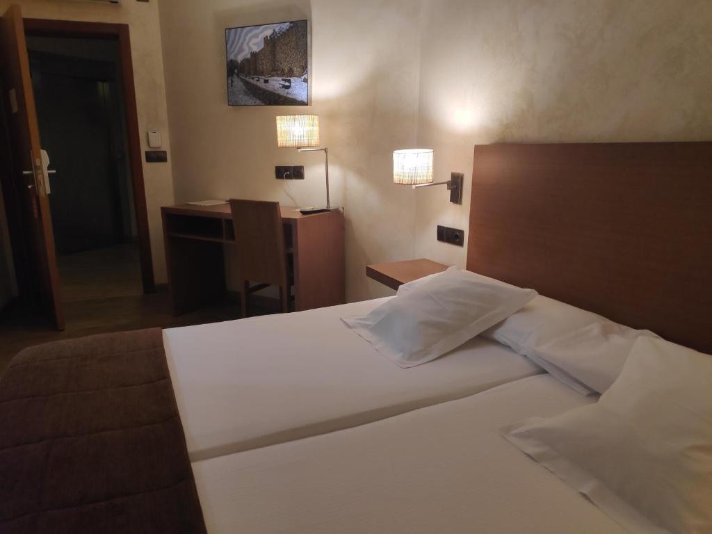 Postel nebo postele na pokoji v ubytování Hotel Las Leyendas