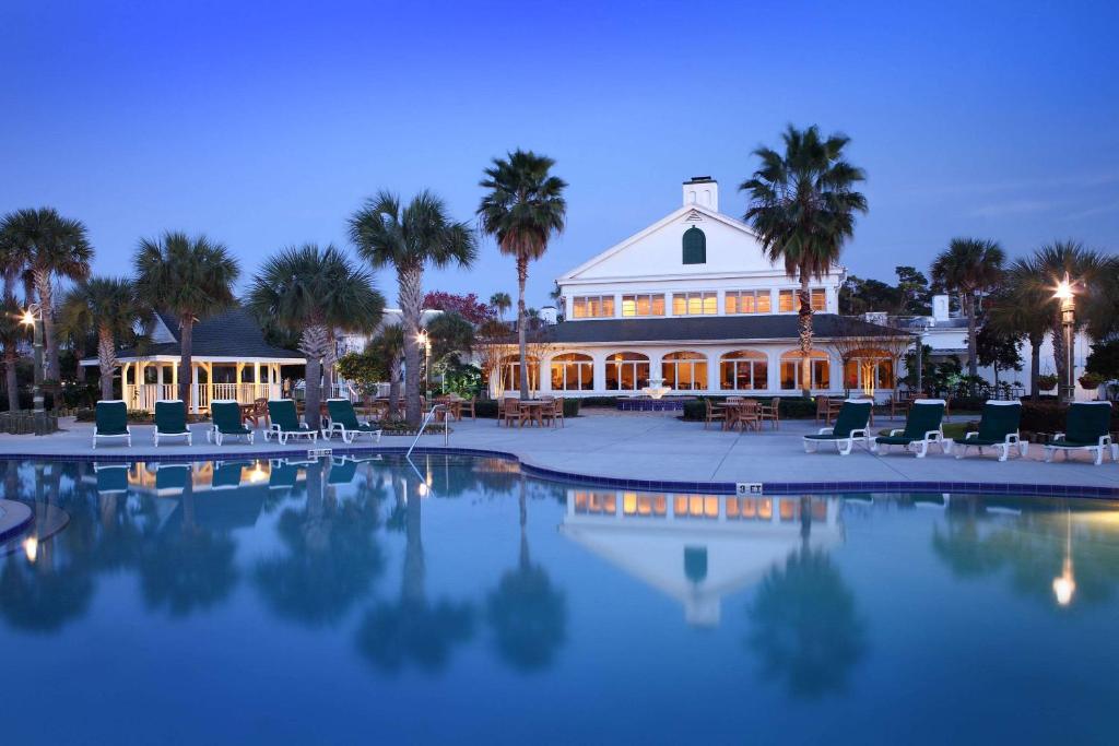 a large house with a pool in front of it at Plantation Resort on Crystal River, Ascend Hotel Collection in Crystal River
