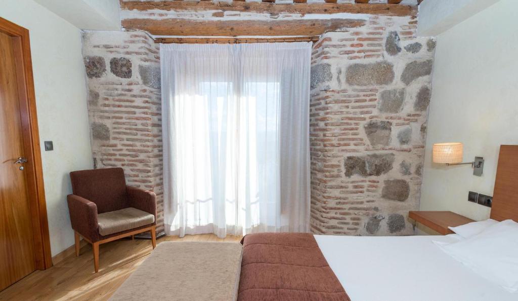 Postel nebo postele na pokoji v ubytování Hotel Las Leyendas