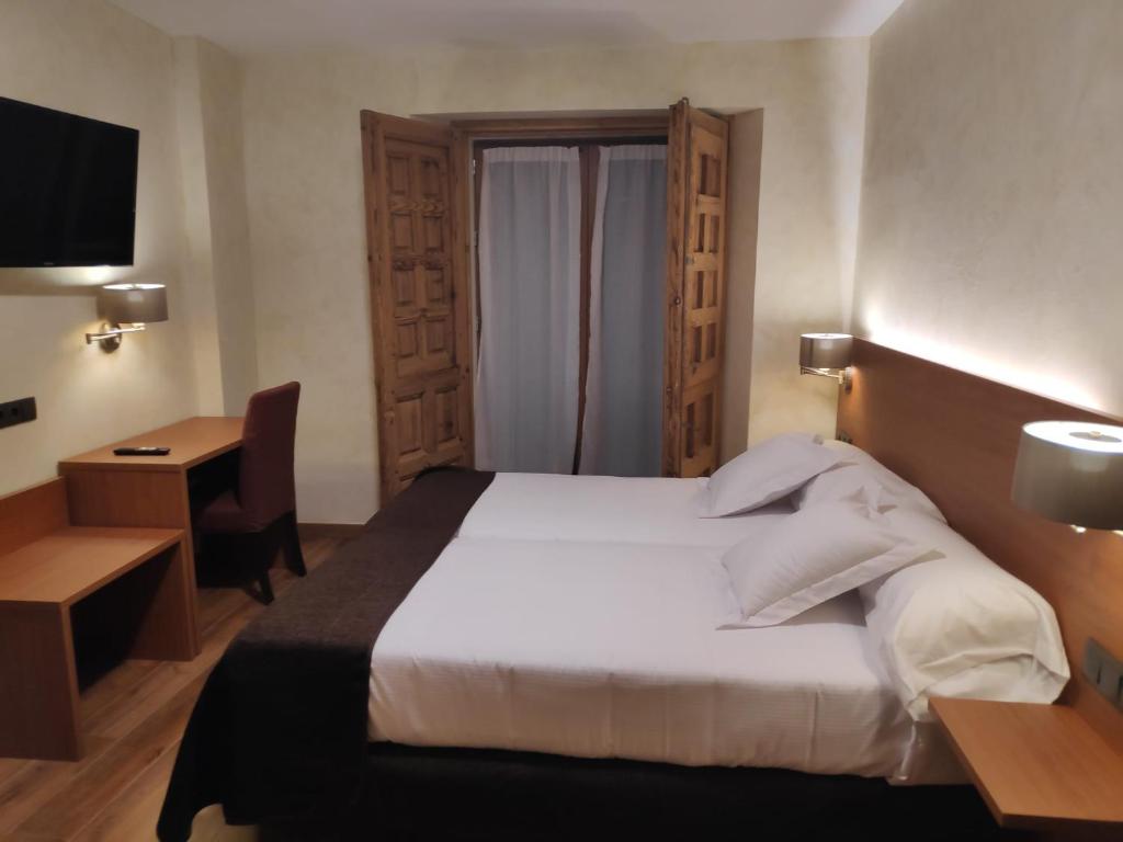 Postel nebo postele na pokoji v ubytování Hotel Las Leyendas