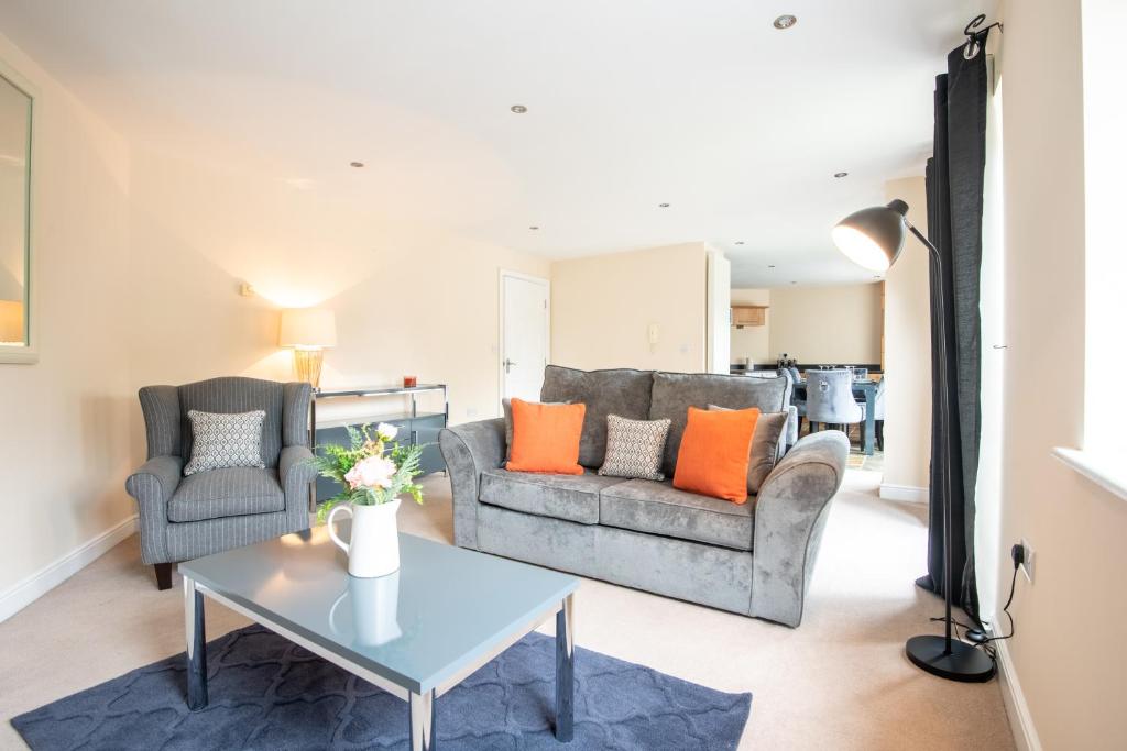 a living room with two couches and a table at Apartment 9 in Worksop