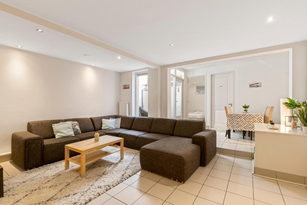 a living room with a couch and a table at Spacious apartment in city center with private patio in Amsterdam