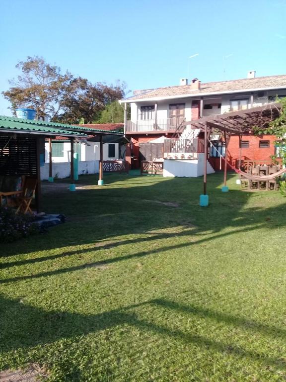 a house with a yard with a playground at Residencial Gil in Palhoça