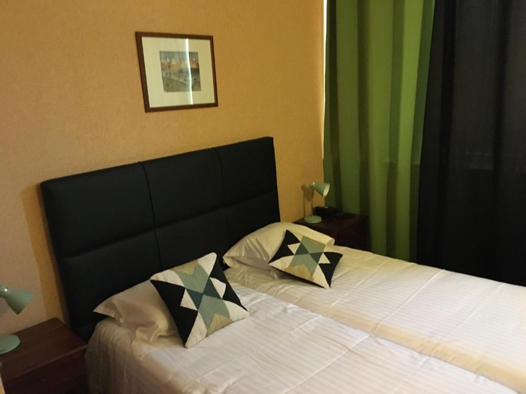 Postel nebo postele na pokoji v ubytování Hotel Dorele
