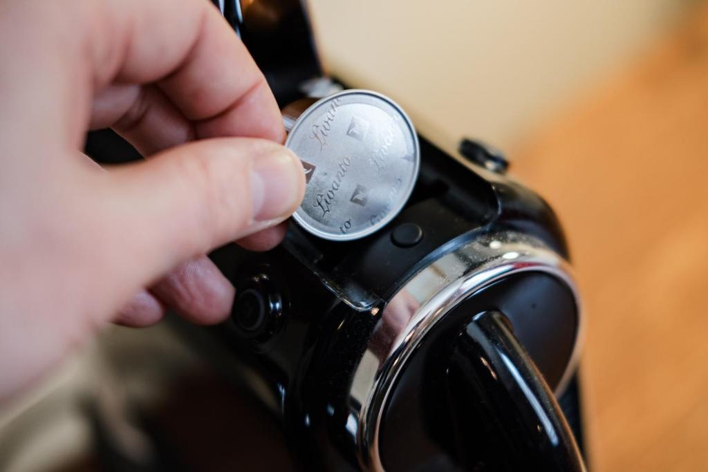 a person is putting a gauge on a watch at Wykeham Arms in Winchester