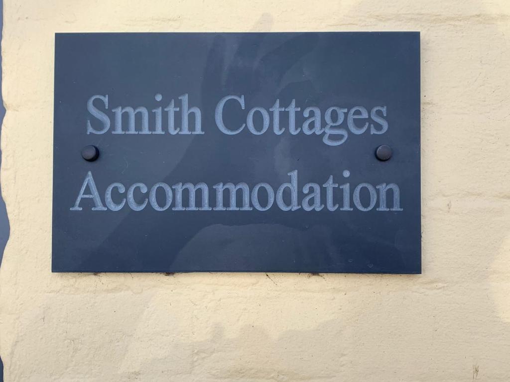 a blue sign on the side of a building at No. 5 Smith Cottages in Langport