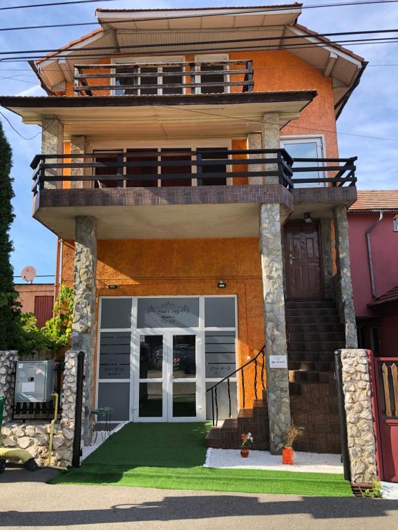 a house with a balcony on top of it at Casa B&D Residence in Deva