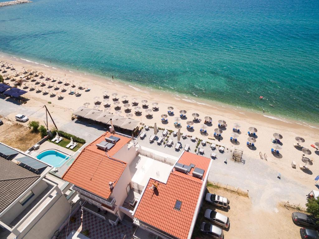 an aerial view of a beach with chairs and umbrellas at Xenia Suites in Limenaria
