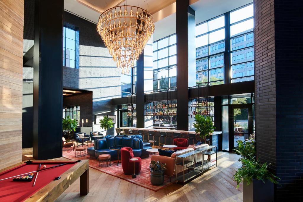 a lobby with a ping pong table and a chandelier at Virgin Hotels Nashville in Nashville
