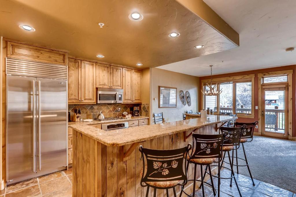 a kitchen with a large island with bar stools at Antlers in Steamboat Springs