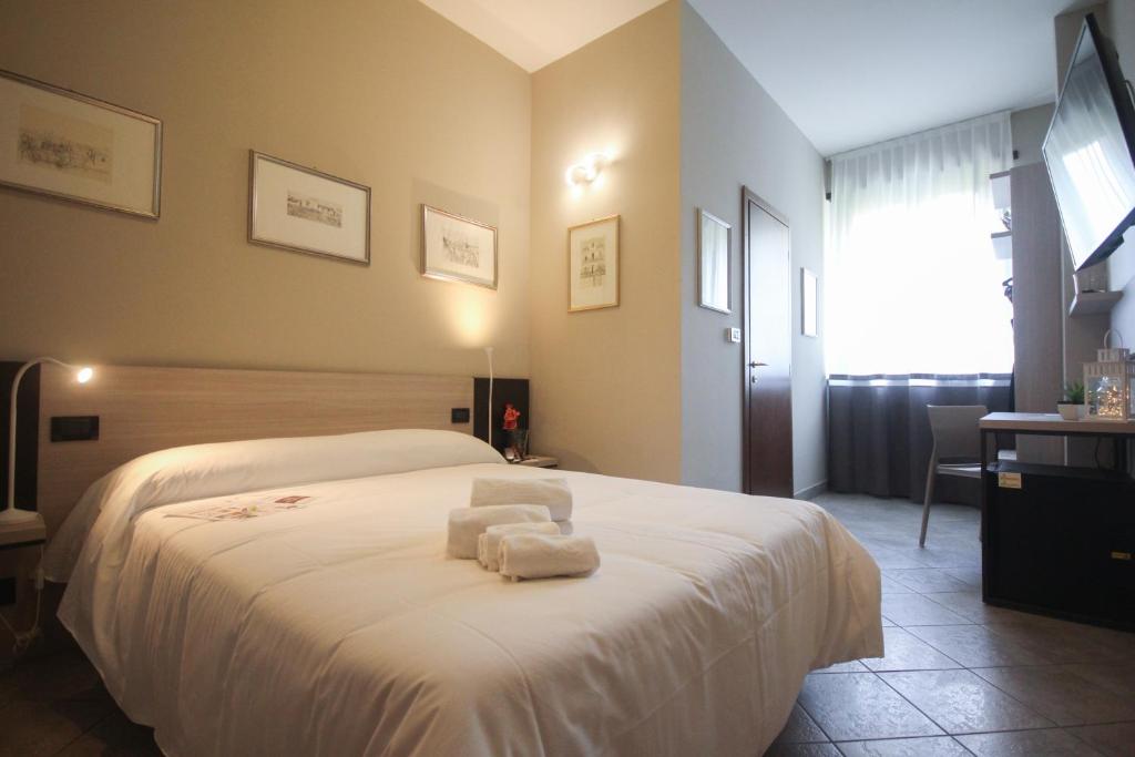 Postel nebo postele na pokoji v ubytování Hotel Gran Torino