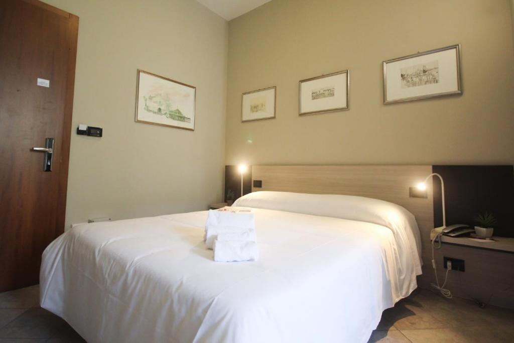 Postel nebo postele na pokoji v ubytování Hotel Gran Torino