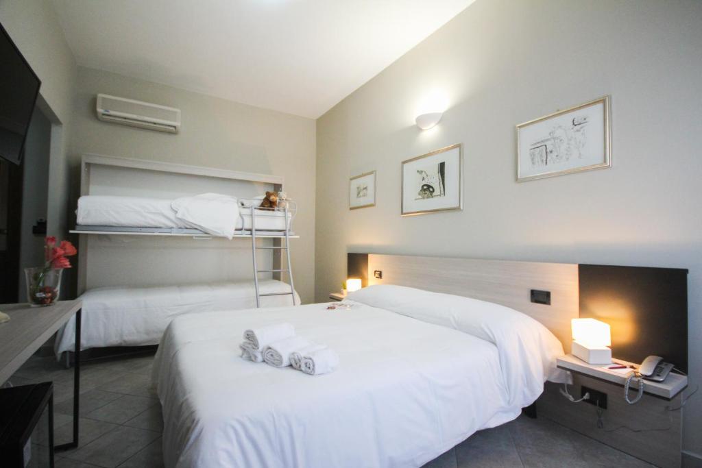 Postel nebo postele na pokoji v ubytování Hotel Gran Torino