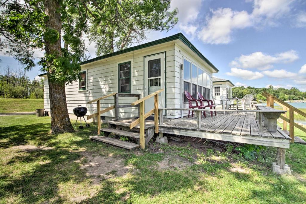 a tiny house with a deck and a tree at Pet-Friendly Beachfront Dent Cabin w/ Grill! in Dent