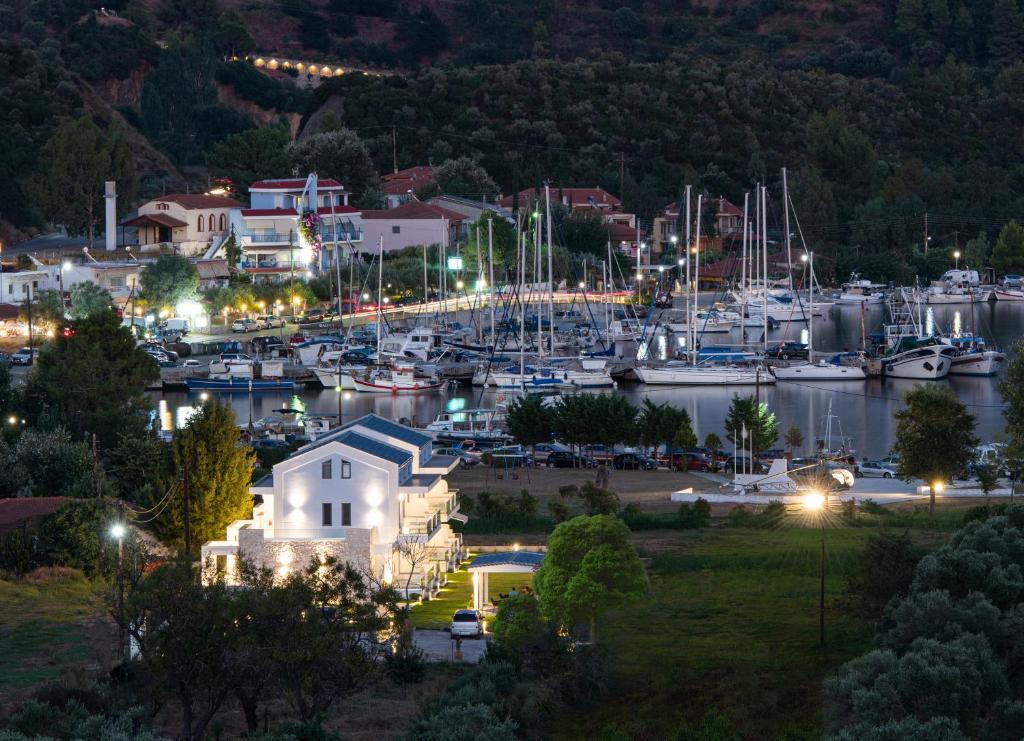 a marina at night with boats in the water at Notia Luxury Living in Porto Koufo