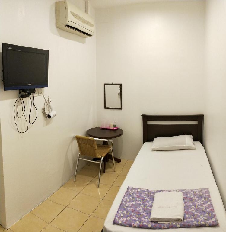 Postel nebo postele na pokoji v ubytování Hotel Tanjong