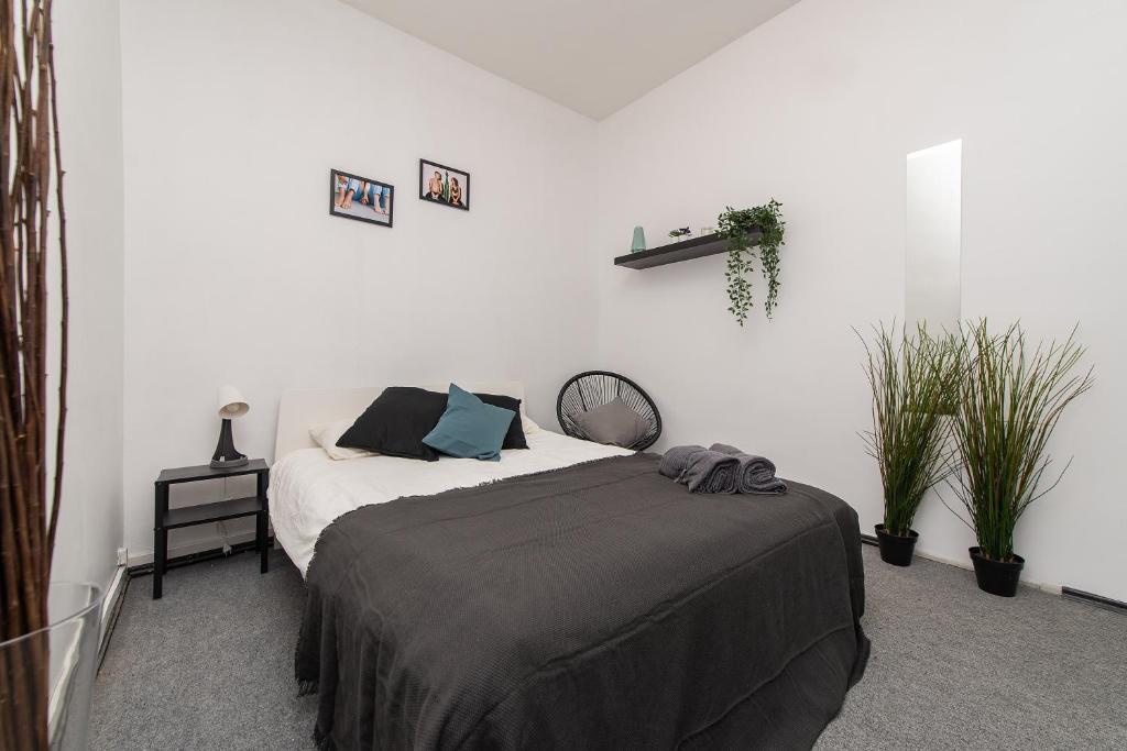 a bedroom with a bed in a white room at The house black in Vilnius