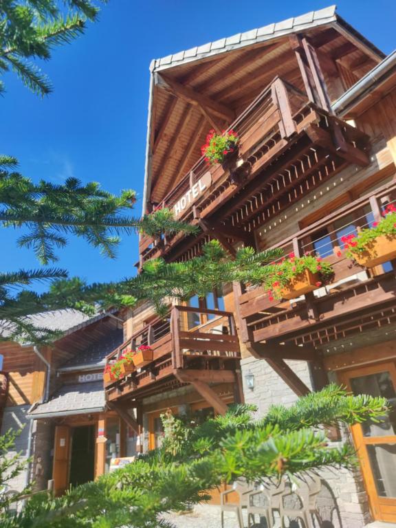 a building with balconies and potted plants on it at l'Ecrin des Neiges in La Joue du Loup