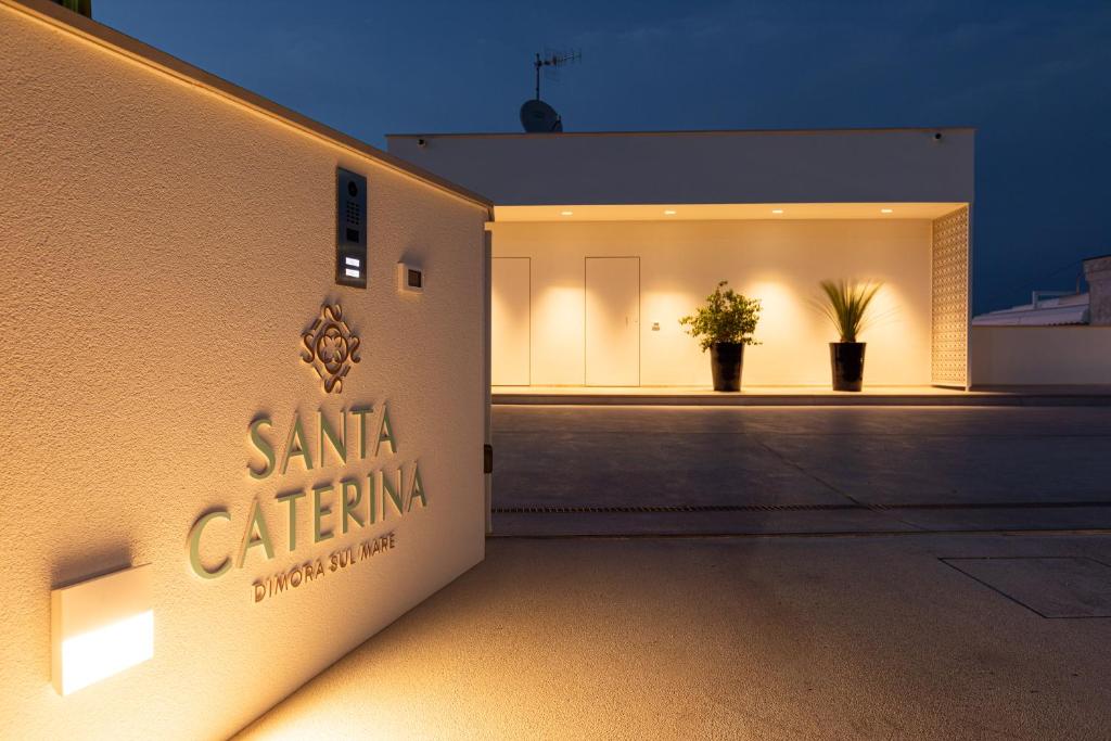 a building with a santa catina sign on the side at Santa Caterina - Dimora sul mare in Polignano a Mare