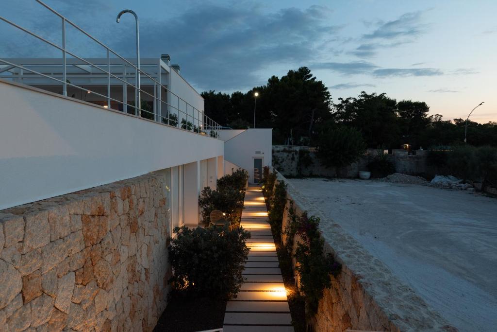 a fence with lights on it next to a building at Santa Caterina - Dimora sul mare in Polignano a Mare