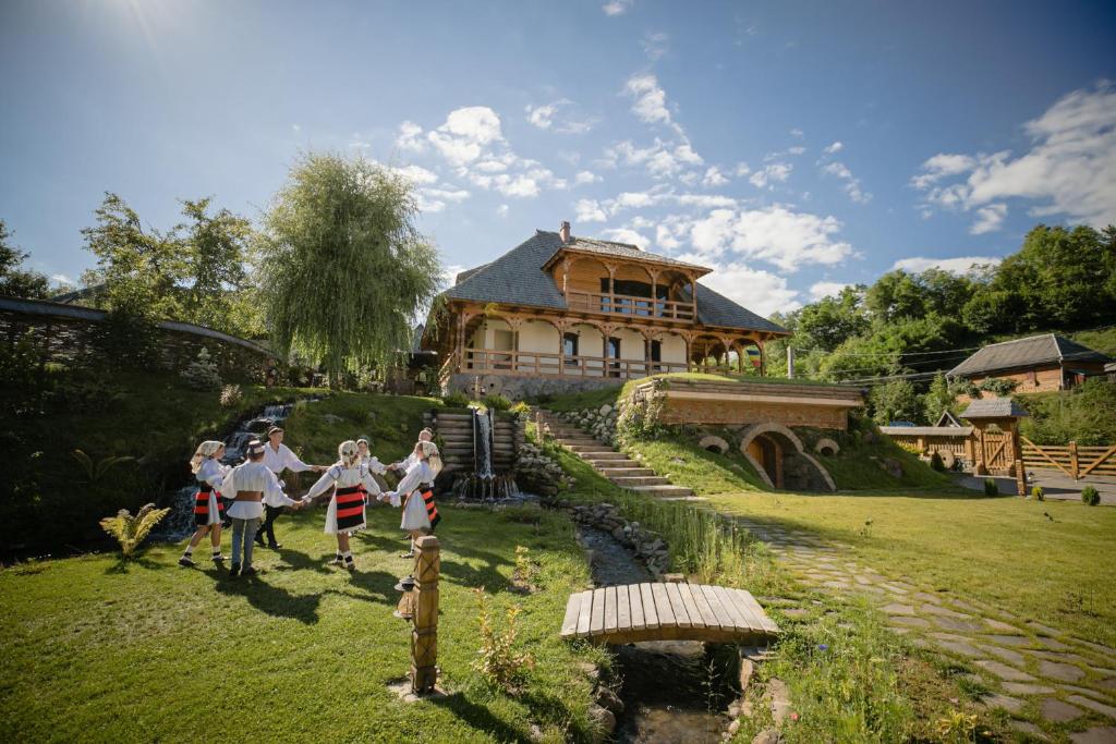 a group of people standing in front of a house at Glodeanca in Glod