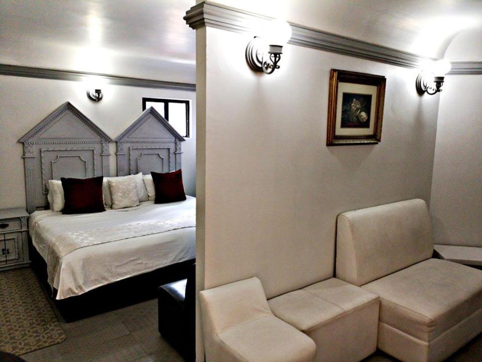 Postel nebo postele na pokoji v ubytování Hotel Hacienda los Narcisos