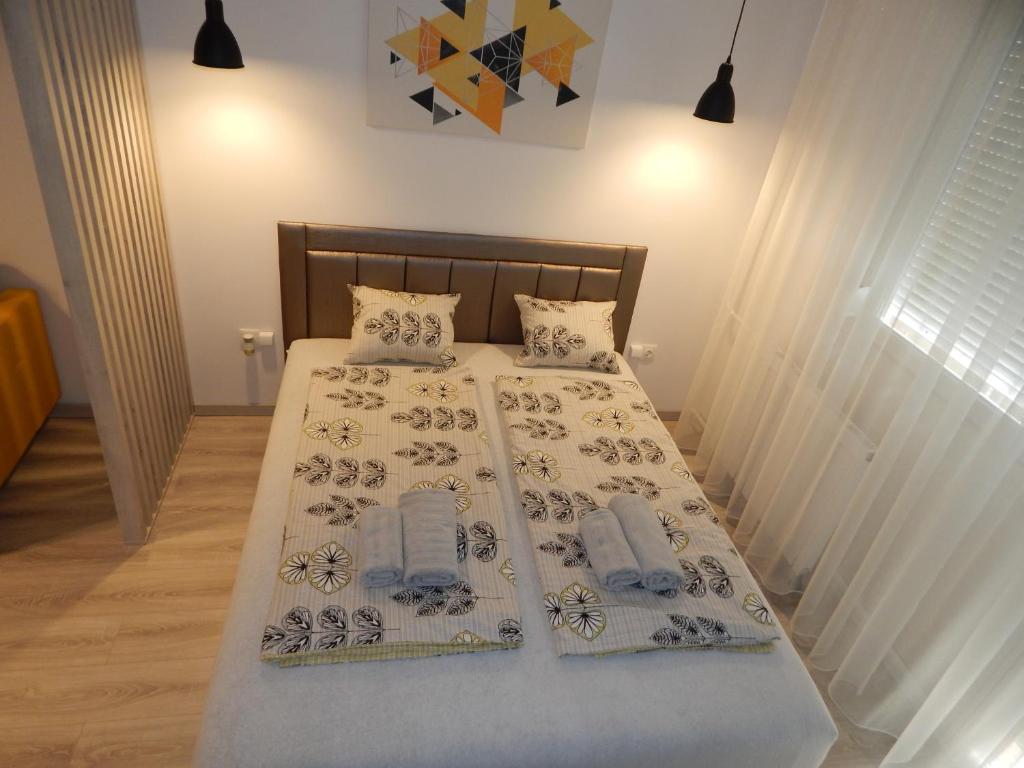 A bed or beds in a room at Pisztácia 2020 Apartman