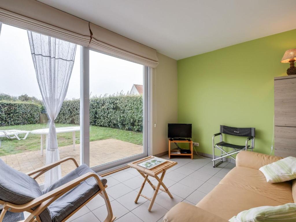 a living room with a couch and a large window at Cosy holiday home with garden in Wimereux in Wimereux
