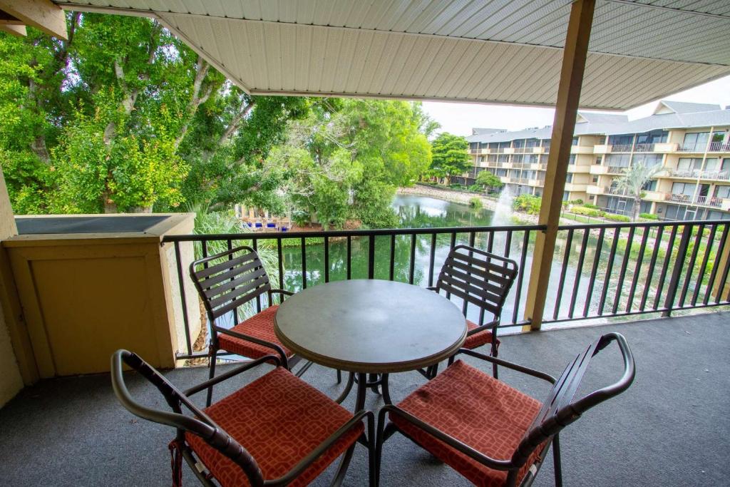 a patio with a table and chairs on a balcony at Park Shore Resort 3rd Floor Bldg H in Naples