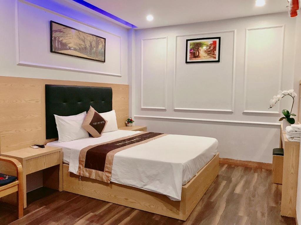 Postel nebo postele na pokoji v ubytování Hotel Việt Mỹ