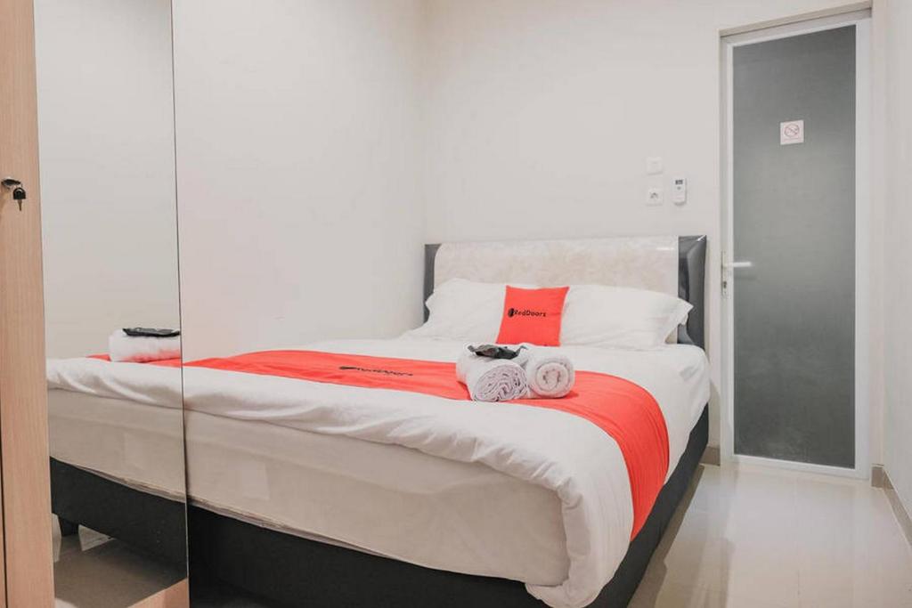 Postel nebo postele na pokoji v ubytování RedDoorz Plus near Soekarno Hatta Airport Taman Mahkota