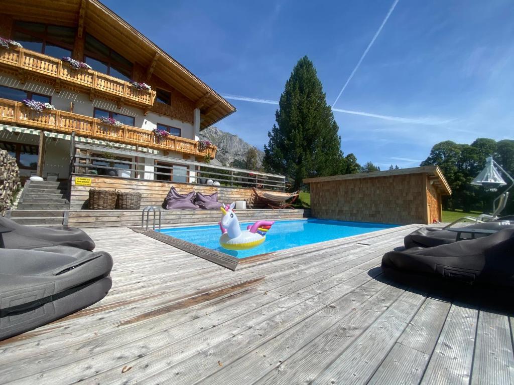 a pool with a inflatable rubber duck in a backyard at Haus Bernhard in Ramsau am Dachstein