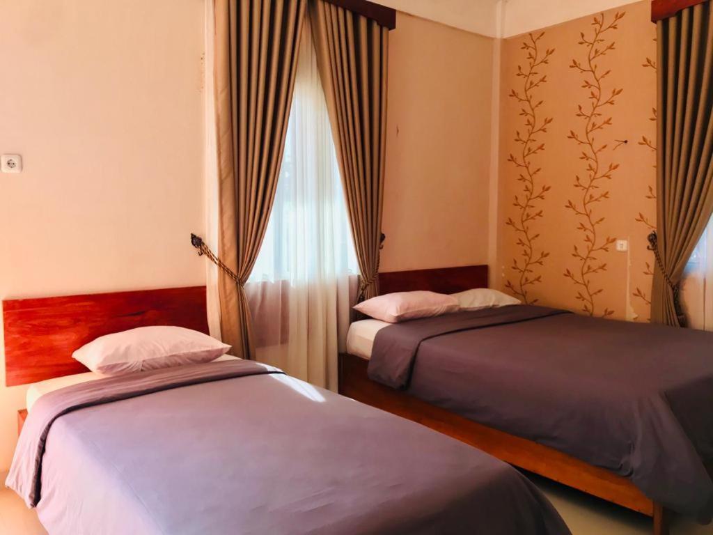 Postel nebo postele na pokoji v ubytování Penginapan Intan Bandara