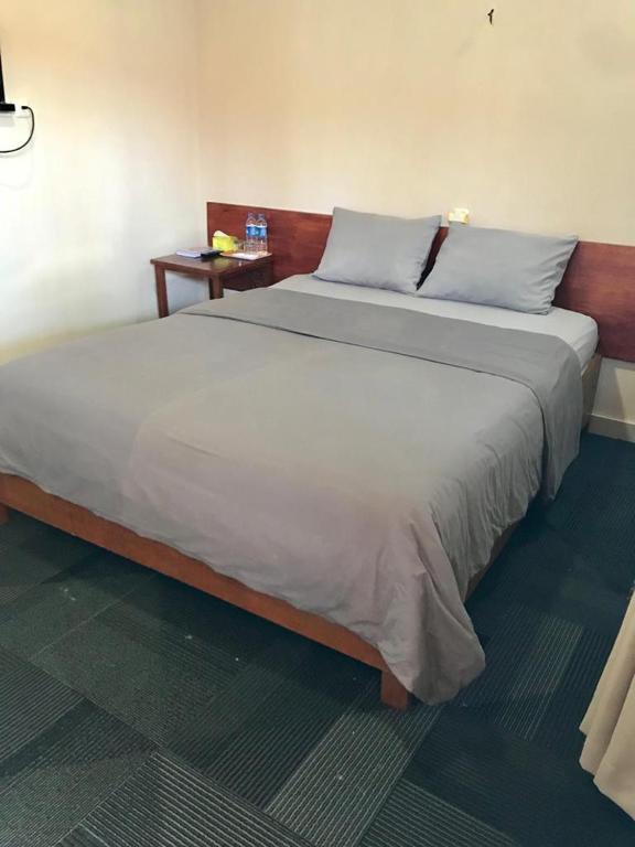 Postel nebo postele na pokoji v ubytování Penginapan Intan Bandara