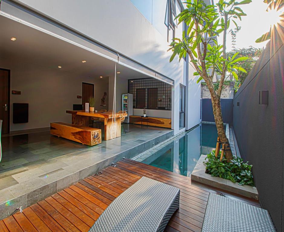 a house with a swimming pool with a palm tree at M Studio Karawaci in Tangerang