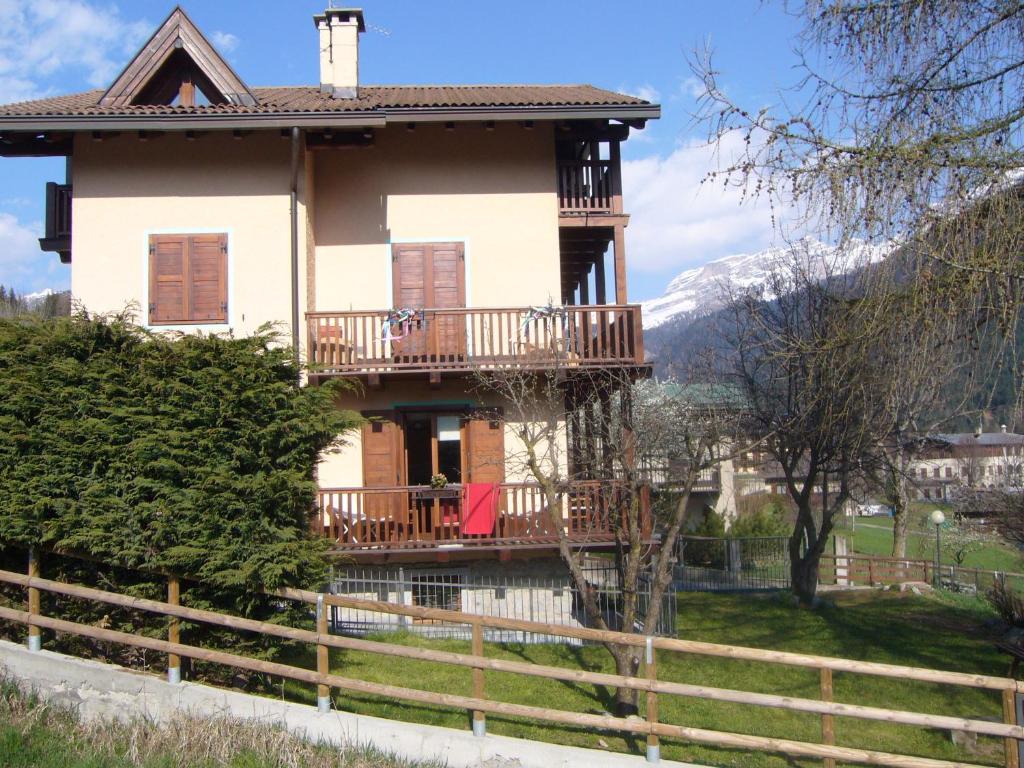 a house in the mountains with a balcony at Chalet Madonna di Campiglio CIPAT ZERO22143-AT-ZERO69206 in Madonna di Campiglio