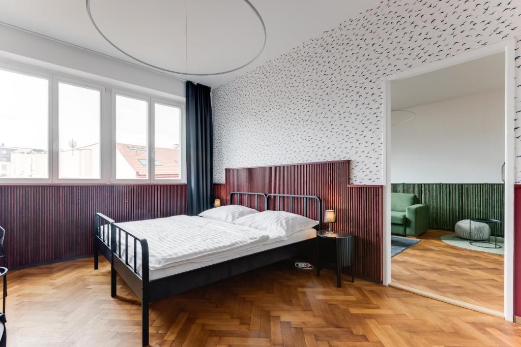 sypialnia z łóżkiem i dużym oknem w obiekcie Apartment Petrska w Pradze