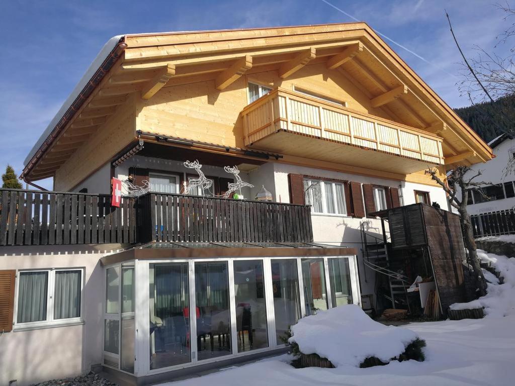 a house with a balcony on top of it at Casa Berger in Bolgen