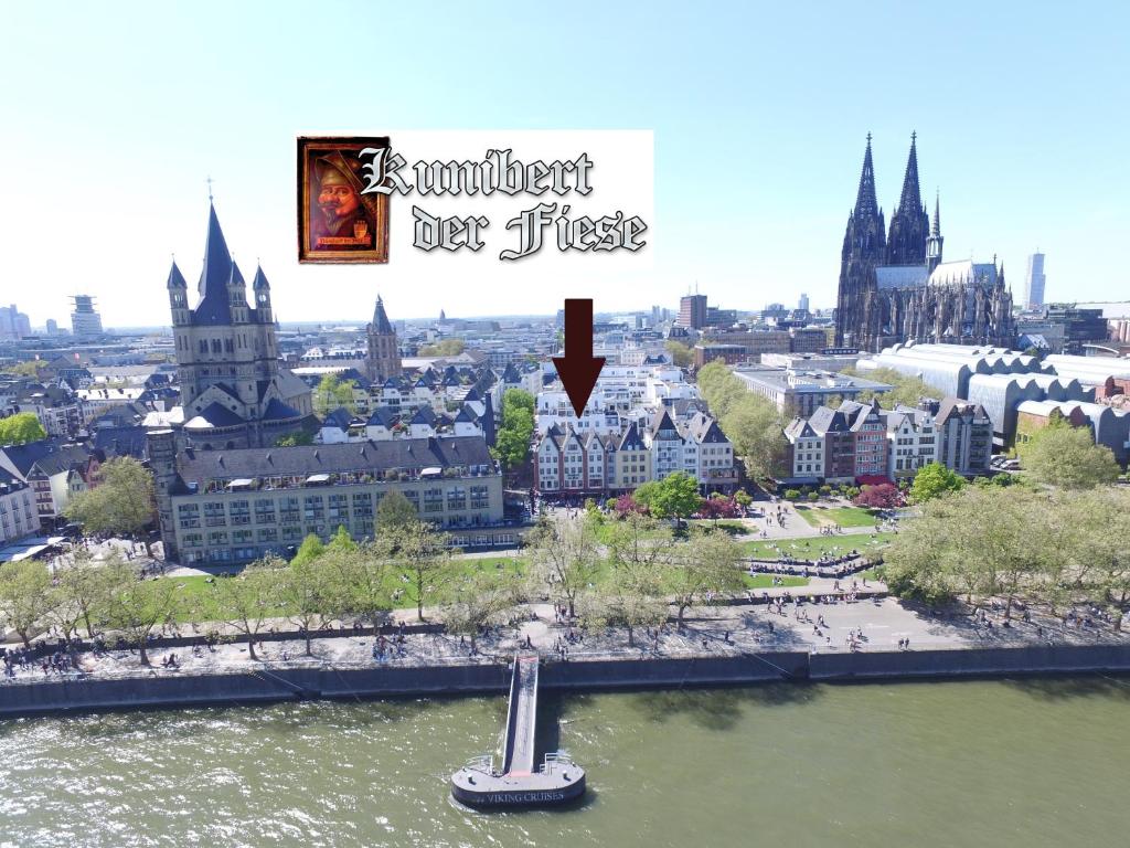 a view of a city with a boat in the water at Hotel Kunibert der Fiese - Superior in Cologne