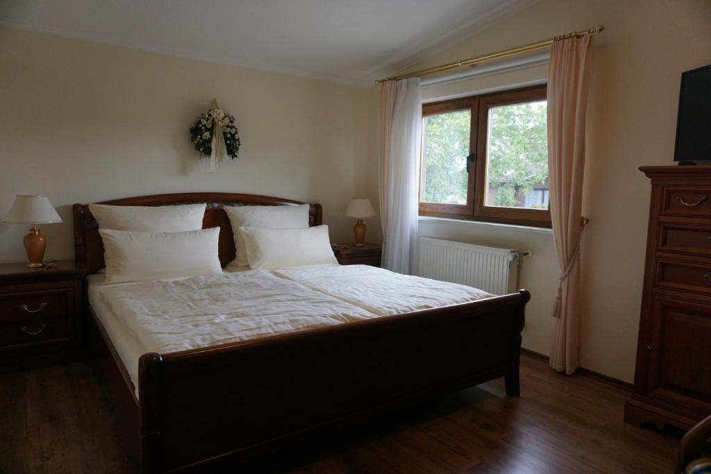 a bedroom with a large bed and a window at Landgasthof “Zur Alten Mühle“ in Plaidt