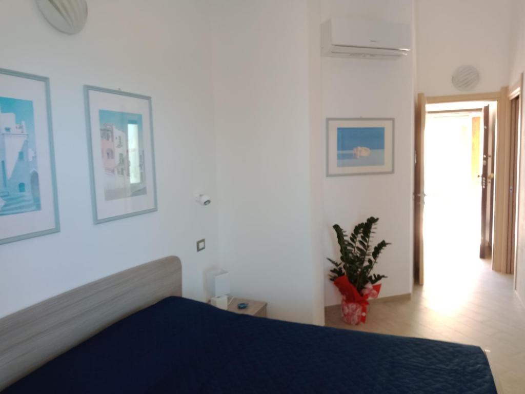 1 dormitorio con 1 cama con colcha azul en Affittacamere Aurora da Nonna Orsola, en Villaputzu
