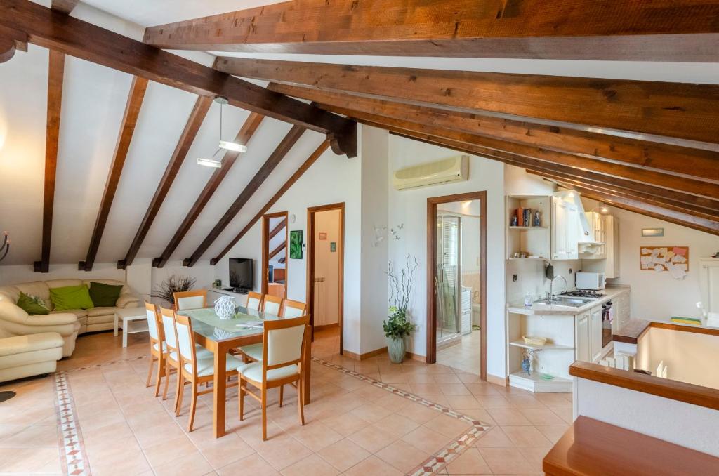 a living room with wooden ceilings and a table and chairs at Ca Do Pescou in Rapallo