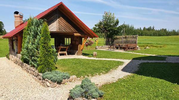 a small cabin in the middle of a yard at Lielie Kupri in Lautere