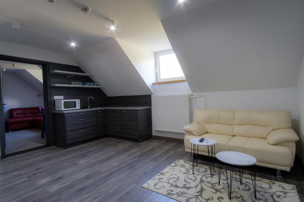 a living room with a couch and a table at Villa Zarra in Habovka