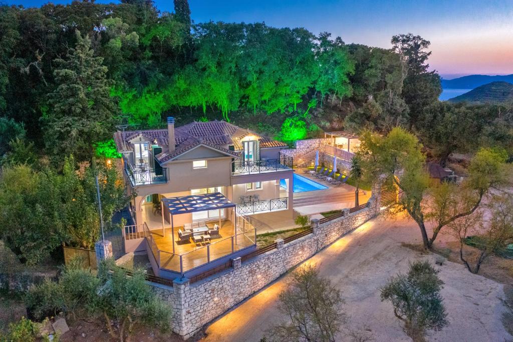 an aerial view of a house with a swimming pool at Andromeda Villa in Vasilikos