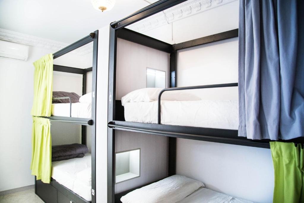 a bedroom with two bunk beds and a window at Hostel One Catedral in Seville