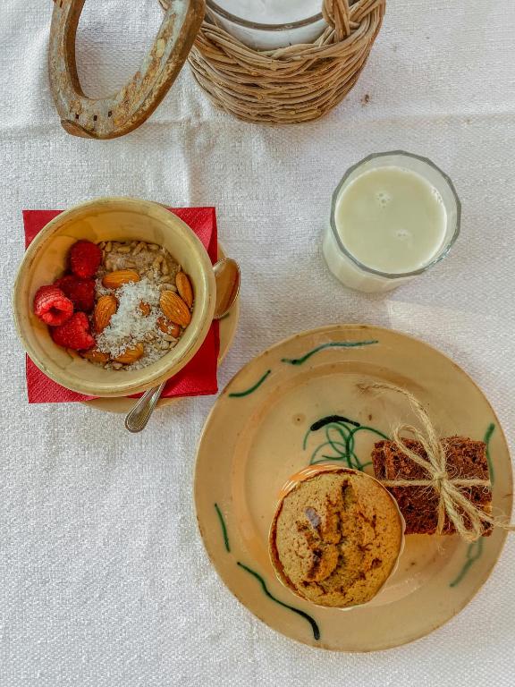 a table with a plate of food and a bowl of food at Masseria Spina Resort in Monopoli