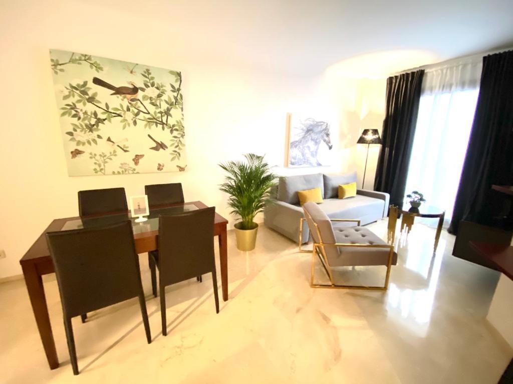 a living room with a dining table and a couch at Portico Sevilla in Seville
