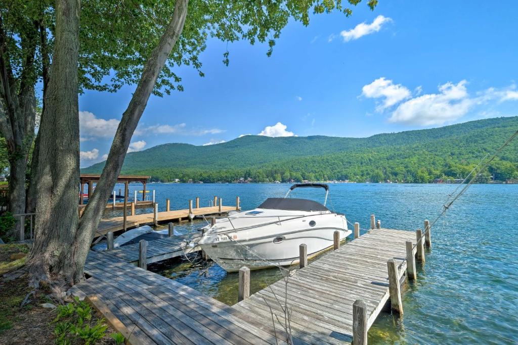 a boat is docked at a dock on a lake at Waterfront Home on Lake George with Boat Dock! in Queensbury